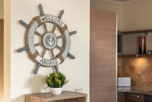 a wooden ship wheel on a wall next to a table at AirHome - The Admiral House in Tallinn