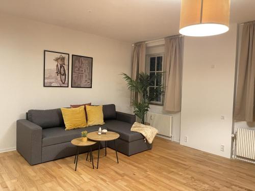 a living room with a couch and a table at aday - Large terrace and 2 bedrooms apartment in the heart of Randers in Randers