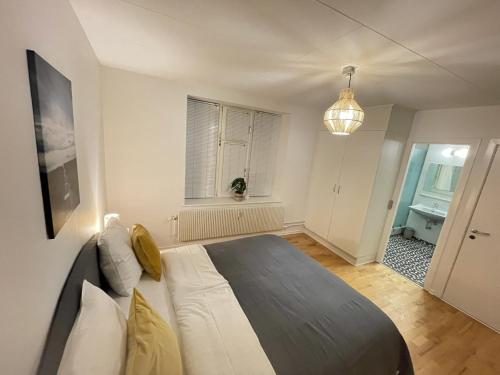 Un dormitorio con una cama grande y una ventana en aday - Large terrace and 2 bedrooms apartment in the heart of Randers en Randers