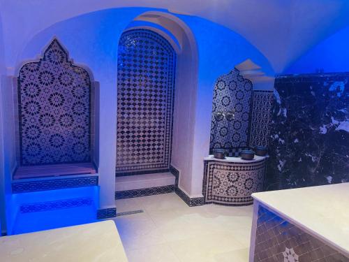 a blue room with two chairs and a table at Riad El Palacio & Spa Chaouen in Chefchaouene
