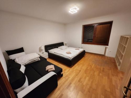 a bedroom with two beds and a window at RG Apartments in Šamorín