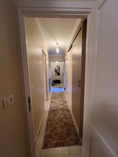 a hallway leading into a home with a hallway at Luxurious VIP Apartment in Madinaty Furnished with High End Hotel Furniture in Madinaty