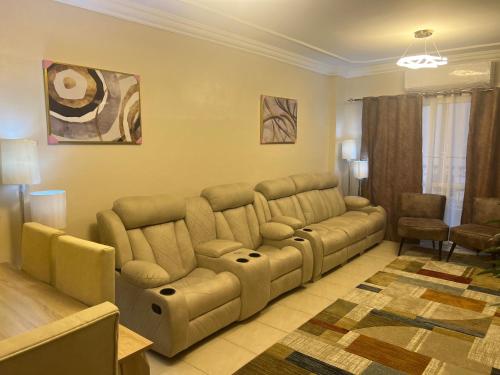 a living room with a couch and a table at Luxurious VIP Apartment in Madinaty Furnished with High End Hotel Furniture in Madinaty