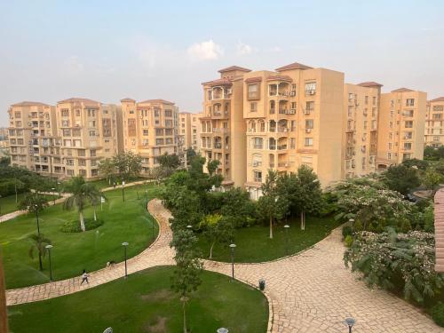 a view of a park in a city with tall buildings at Luxurious VIP Apartment in Madinaty Furnished with High End Hotel Furniture in Madinaty