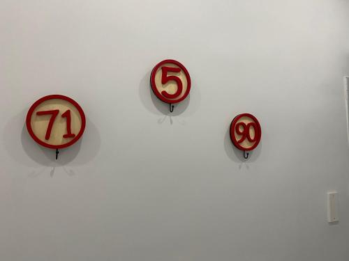 a group of signs on a white wall at Isla Home in Naples