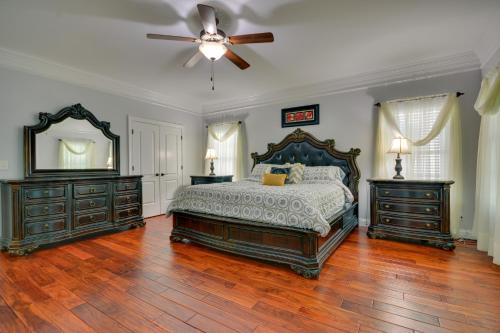 a bedroom with a bed and two dressers and a ceiling fan at High Point Vacation Rental with Private Deck! in High Point