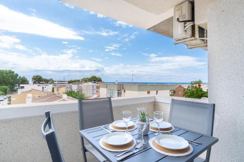 a table and chairs on a balcony with a view of the ocean at Luxe - Penthouse - 2BR - Seaview - Beach - Parking in Creixell