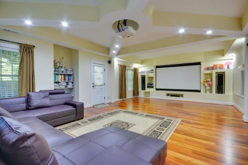 a living room with a couch and a flat screen tv at High Point Vacation Rental with Private Deck! in High Point