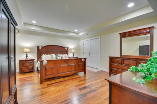 a bedroom with a bed and a large mirror at High Point Vacation Rental with Private Deck! in High Point