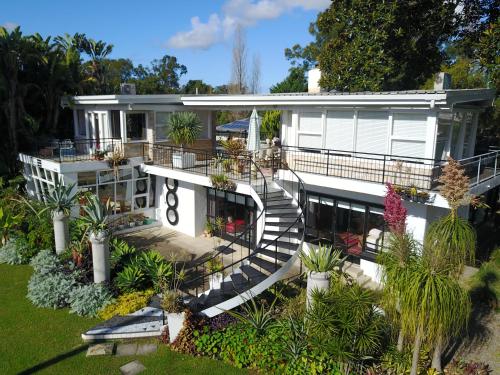 a large white house with stairs and plants at Belairberry in Berry