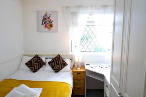 a bedroom with a bed and a desk and a window at 4 bedroom property in Birmingham in Birmingham
