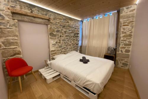 a bedroom with a bed and a red chair at Le Rivet charmant 12 personnes Terreaux in Lyon