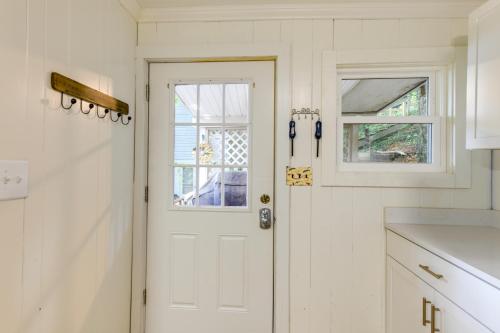 een keuken met een witte deur en een raam bij Horseshoe Lake Vacation Rental with Deck and Kayaks! in Batavia