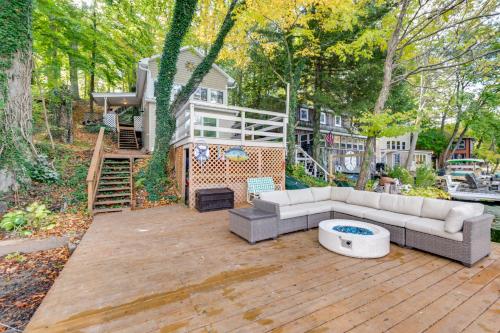 a patio with a couch and a table and a house at Horseshoe Lake Vacation Rental with Deck and Kayaks! in Batavia