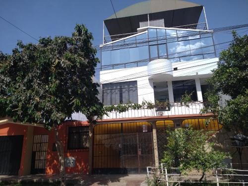 a tall white building with a fence in front of it at LUGAR DE DESCANSO in Ica