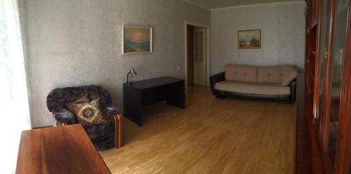 a living room with a couch and a table at Graz Narek house 5 in Altenfelden