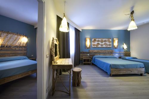 En eller flere senge i et værelse på Hotel Tirreno