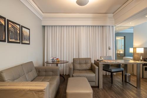a living room with a couch and a table at Blue Tree Premium Florianópolis in Florianópolis