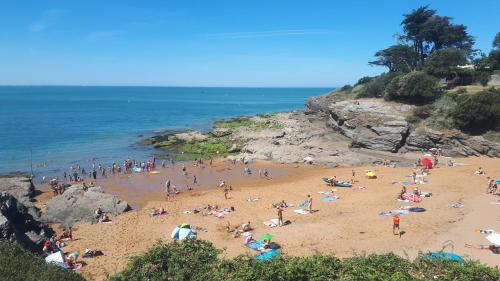 a large group of people on a beach at Studio in Pornic