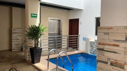 a swimming pool in the middle of a building at Villanueva Suite’s in Chacala