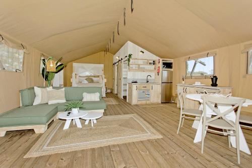 a living room with a couch and a table and a kitchen at Ingenia Holidays Bonny Hills in Bonny Hills