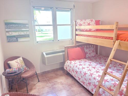 a small room with a bunk bed and a chair at Come, Enjoy & Relax Bosque del Mar 1 Rio Grande, PR in Rio Grande
