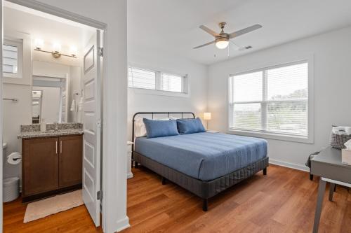 a bedroom with a bed and a bathroom at Charming Duplex Retreat in Old Town Manchester, VA in Richmond