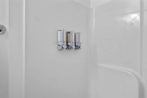 a bathroom with a soap dispenser on a wall at Charming Duplex Retreat in Old Town Manchester, VA in Richmond