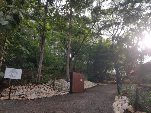 a wooden gate in the middle of a dirt road at Baliyana Lodge in San José Pinilla