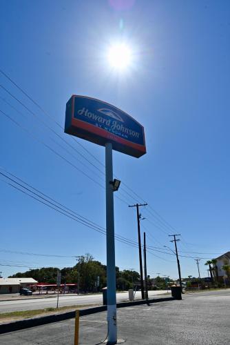 a sign on a pole in the middle of a street at Howard Johnson by Wyndham Near Schlitterbahn in New Braunfels