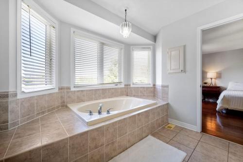 a bath tub in a bathroom with a window at The house in Ottawa