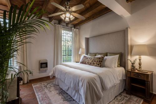 a bedroom with a large bed and a ceiling fan at 3BR Garden Home with Rooftop & Garage in Centro San Miguel de Allende in San Miguel de Allende