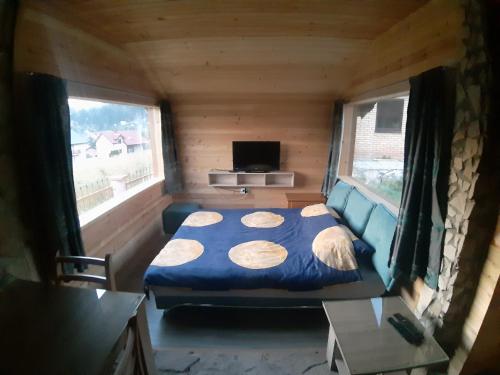 a small bedroom with a bed in a tiny house at Biljana Sweet Home in Pale