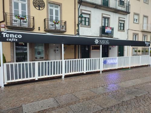 a building with a black awning on a street at Naval Guest House & Bistrô in Vila do Conde