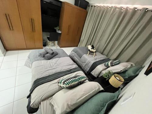 a large bed with a dog sitting on top of it at APTO 1225B Fantástico in Ribeirão Preto