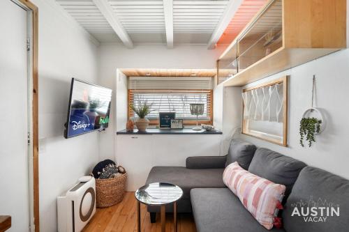a living room with a couch and a table at HGTV Featured Tiny Home w Hot Tub Near East 6th St in Austin