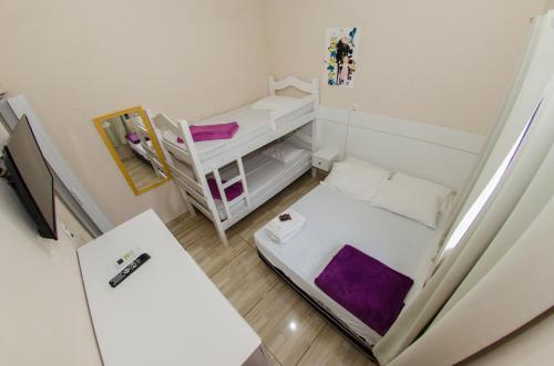 En eller flere senger på et rom på Pousada Esperança