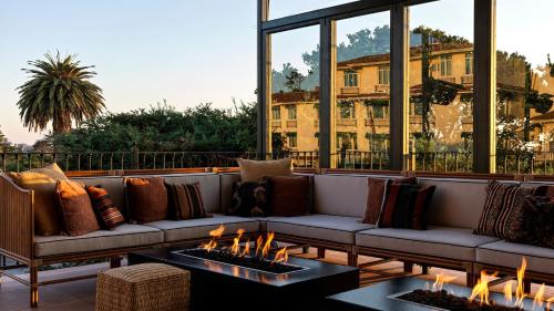 a living room with couches and fires on a patio at La Playa Hotel in Carmel