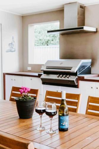 a wooden table with two glasses of wine on it at Dumplings Den in Mudgee