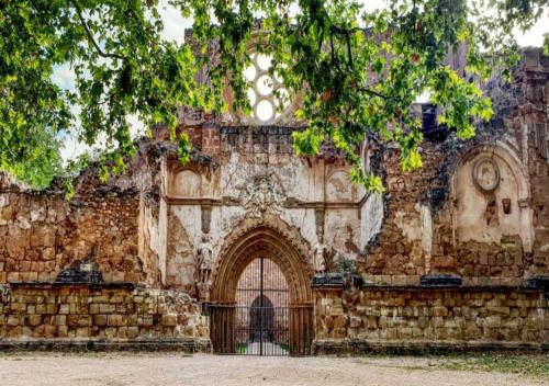 an old stone building with a gate in front at Villa Castro in Nuévalos