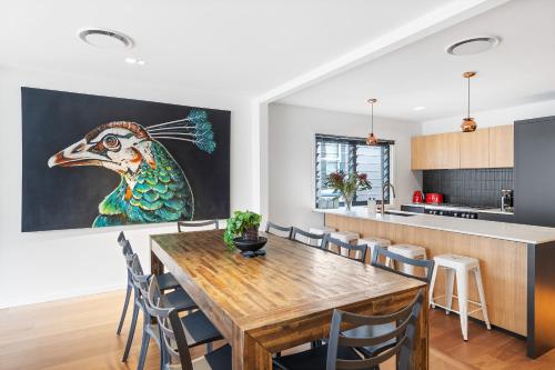 a kitchen and dining room with a wooden table and chairs at Artscape, Newtown Villa in Sydney