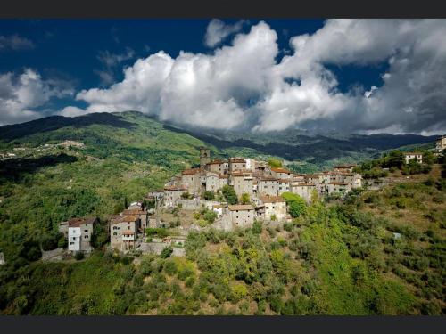un groupe de maisons sur une colline avec des montagnes dans l'établissement La Rocca Sovrana - Casa Vacanze, à Aramo