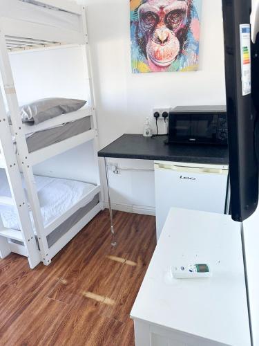 a dorm room with a bunk bed and a desk at 264 rooms in London