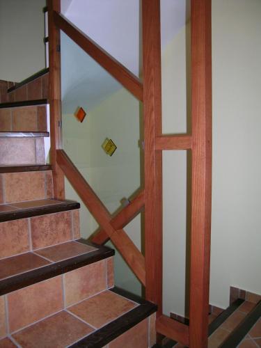 a staircase in a house with wood and glass at Domus Lilio in Petralia Sottana