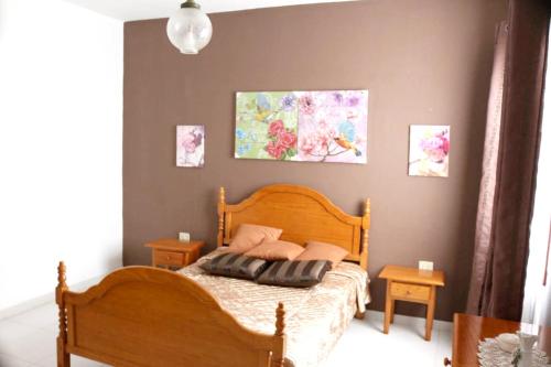 a bedroom with a wooden bed with pillows on it at Welcoming apartment with mountain view in El Paso