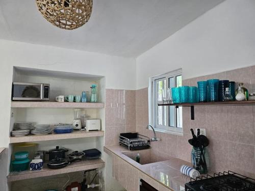 a kitchen with a sink and a counter top at La Casita de Chelem in Chelem
