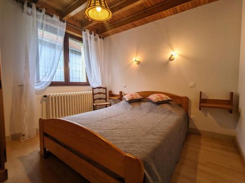 um quarto com uma cama grande e uma janela em Gîte La Bresse, 3 pièces, 4 personnes - FR-1-589-127 em La Bresse