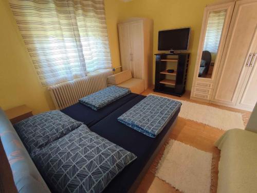 a living room with two beds and a television at Holiday home in Siofok - Balaton 45811 in Siófok