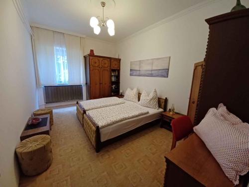 a large bedroom with a bed and a couch at Holiday home in Balatonboglar 45807 in Balatonboglár