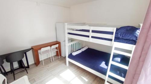a small room with two bunk beds and a table at Flat 6 in Croydon